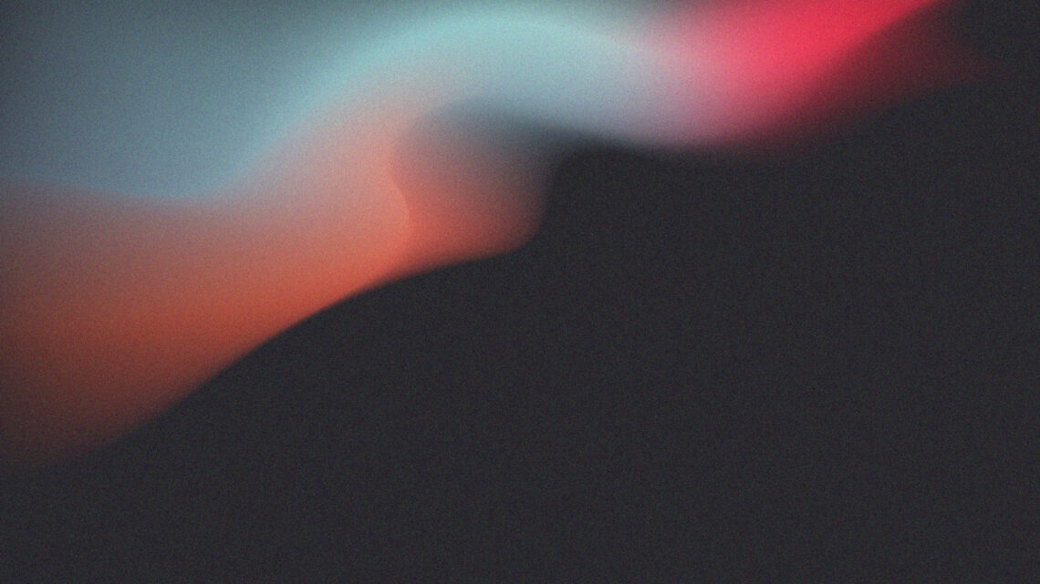 Un'immagine astratta, sgranata, con una specie di onda fatta di tante sfumature di colori diversi - gradienti di arancio, azzurro e rosa - su uno sfondo scuro.