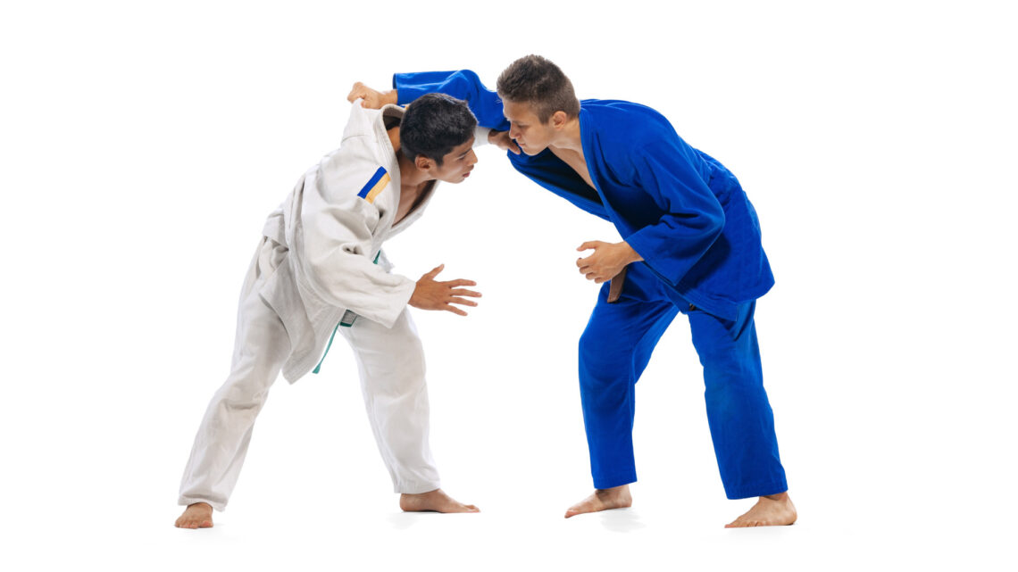 Fotografia che ritrae due judoka che si affrontano su sfondo bianco.