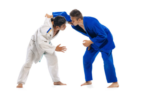 Fotografia che ritrae due judoka che si affrontano su sfondo bianco.